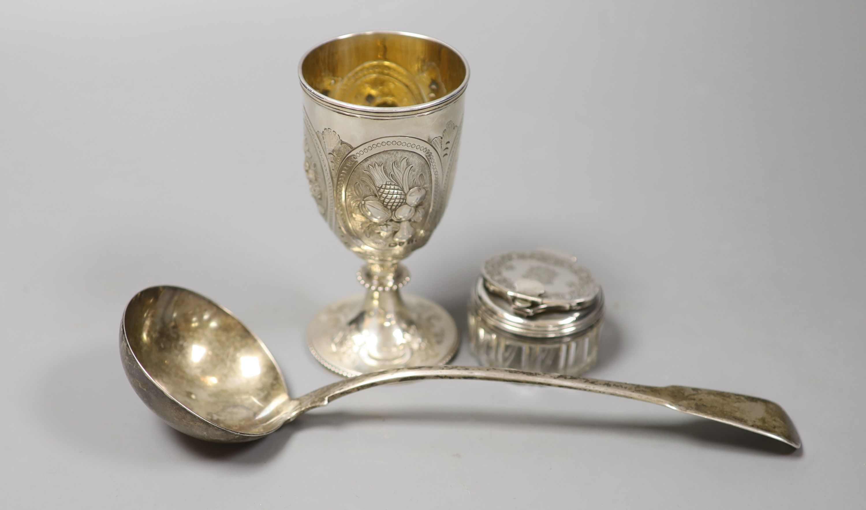 A George III silver fiddle pattern soup ladle, London, 1812, 26.6cm, a Victorian silver goblet, George Angell, London, 1871, 13cm and an early Victorian silver mounted glass travelling inkwell.